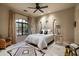 Light bedroom with a four-poster bed, patterned rug, and a arched window with sheer curtains at 6102 E Sage Dr, Paradise Valley, AZ 85253