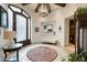 Welcoming foyer with elegant chandelier, travertine floors, and decorative accents at 6102 E Sage Dr, Paradise Valley, AZ 85253