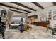 Open-concept living area featuring exposed beams, large windows, and a cozy fireplace at 6102 E Sage Dr, Paradise Valley, AZ 85253
