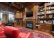 Executive office with wood paneling, custom built-ins, fireplace, and views from the window at 6102 E Sage Dr, Paradise Valley, AZ 85253