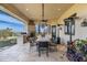 Stylish covered patio featuring a built-in BBQ, fireplace, and ample dining space perfect for entertaining guests at 6102 E Sage Dr, Paradise Valley, AZ 85253