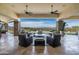 Inviting covered outdoor living area with comfortable seating, ceiling fans, and picturesque mountain views at 6102 E Sage Dr, Paradise Valley, AZ 85253