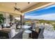Relaxing covered patio featuring comfortable seating and scenic views of the manicured backyard and surrounding landscape at 6102 E Sage Dr, Paradise Valley, AZ 85253