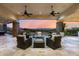 Inviting outdoor patio with comfortable seating, ceiling fans, stone columns, and scenic mountain views at 6102 E Sage Dr, Paradise Valley, AZ 85253