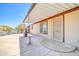 Spacious covered back porch with concrete flooring and access to home at 6921 W Wanda Lynn Ln, Peoria, AZ 85382