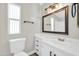 Bright bathroom features a white vanity with modern hardware, framed mirror, and neutral wall color at 6921 W Wanda Lynn Ln, Peoria, AZ 85382