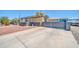 Wide driveway with desert landscape design surrounding the single story home at 6921 W Wanda Lynn Ln, Peoria, AZ 85382