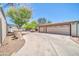 Driveway and a three car garage. Side of the house shows some storage at 6921 W Wanda Lynn Ln, Peoria, AZ 85382