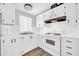 Bright kitchen featuring white cabinets, tile backsplash, and modern appliances at 6921 W Wanda Lynn Ln, Peoria, AZ 85382