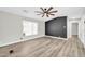 Modern living room with sleek wood floors, neutral walls, and a stylish ceiling fan at 6921 W Wanda Lynn Ln, Peoria, AZ 85382