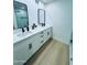 Bathroom with dual sinks, black fixtures, and walk-in glass shower at 727 W Maryland Ave # 1, Phoenix, AZ 85013