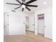 Minimalist bedroom showing a ceiling fan, closet, ensuite, and neutral walls at 727 W Maryland Ave # 1, Phoenix, AZ 85013
