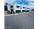 Street view of townhouses featuring private garages, manicured landscaping, and inviting curb appeal at 727 W Maryland Ave # 1, Phoenix, AZ 85013