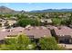 Aerial view of home in desert neighborhood showing backyard with fire pit, and mountain views at 7291 E Eagle Feather Rd, Scottsdale, AZ 85266
