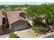 Aerial view of a home showing the roof and landscaping with a desert view in the background at 7291 E Eagle Feather Rd, Scottsdale, AZ 85266