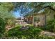 Beautifully landscaped backyard features a fire pit, outdoor seating area, and built in BBQ at 7291 E Eagle Feather Rd, Scottsdale, AZ 85266