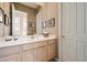 Bathroom featuring a vanity with double sinks, large mirror, and white trim at 7291 E Eagle Feather Rd, Scottsdale, AZ 85266