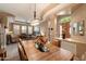Open dining room with wood table set and entry to the living room at 7291 E Eagle Feather Rd, Scottsdale, AZ 85266