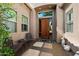Inviting front porch with decorative chairs, a table, and elegant doorway at 7291 E Eagle Feather Rd, Scottsdale, AZ 85266