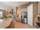 Well-lit kitchen with stainless steel appliances and ample counter space adjacent to an open floor plan living space at 7291 E Eagle Feather Rd, Scottsdale, AZ 85266