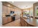 Spacious kitchen with large island, stainless steel appliances, tiled backsplash and adjoining breakfast nook at 7291 E Eagle Feather Rd, Scottsdale, AZ 85266