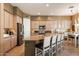 Bright and airy kitchen boasts large island, stainless appliances, and plentiful cabinets, great for entertaining at 7291 E Eagle Feather Rd, Scottsdale, AZ 85266