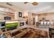 Open-concept living space with fireplace flowing into kitchen with a breakfast bar at 7291 E Eagle Feather Rd, Scottsdale, AZ 85266