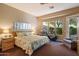 Bright, sunny main bedroom with large windows and cozy carpet at 7291 E Eagle Feather Rd, Scottsdale, AZ 85266