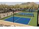 Community pickleball courts surrounded by fencing, landscaping, and parking at 7291 E Eagle Feather Rd, Scottsdale, AZ 85266