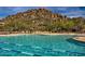 Resort style pool featuring comfortable lounge chairs, clear water and mountain views at 7291 E Eagle Feather Rd, Scottsdale, AZ 85266