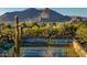 Tennis courts in desert community with mountain views and lush desert landscape at 7291 E Eagle Feather Rd, Scottsdale, AZ 85266