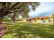 Expansive backyard featuring a pool, mature trees, lush green lawn, and comfortable seating areas at 7307 N 17Th Ave, Phoenix, AZ 85021