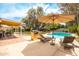 Inviting backyard with a sparkling pool, lounge chairs, and outdoor kitchen with barbeque for relaxing and entertaining at 7307 N 17Th Ave, Phoenix, AZ 85021