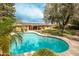 Beautiful backyard showcasing a sparkling pool surrounded by lush landscaping and a charming yellow home exterior at 7307 N 17Th Ave, Phoenix, AZ 85021