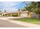 Charming single-story home with yellow siding, a well-manicured lawn, mature landscaping, and a two-car garage at 7307 N 17Th Ave, Phoenix, AZ 85021