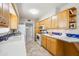 Well-lit kitchen featuring wood cabinetry, ample counter space, and tile flooring at 7307 N 17Th Ave, Phoenix, AZ 85021