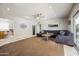 Spacious living room with tile floors, ceiling fan, contemporary furniture, and sliding glass doors to backyard at 7307 N 17Th Ave, Phoenix, AZ 85021