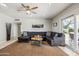 Inviting living room with a cozy sectional sofa, ceiling fan, decorative mirror, and a stylish rug at 7307 N 17Th Ave, Phoenix, AZ 85021