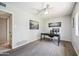 Well-lit home office with gray floors, modern desk setup, neutral walls, and ceiling fan at 7307 N 17Th Ave, Phoenix, AZ 85021
