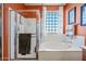 Bright bathroom featuring a walk-in shower, soaking tub, and textured glass block window at 7342 E Norwood St, Mesa, AZ 85207
