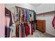 Walk-in closet with ample hanging space and a small chest of drawers at 7342 E Norwood St, Mesa, AZ 85207