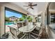 Inviting covered patio with a large table, chairs, and ceiling fan, perfect for outdoor dining and entertaining at 7342 E Norwood St, Mesa, AZ 85207