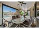 Inviting covered patio with a large table, chairs, and ceiling fan, perfect for outdoor dining and entertaining at 7342 E Norwood St, Mesa, AZ 85207