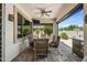 Inviting covered patio featuring a dining area, ceiling fan, and a view of the landscaped backyard at 7342 E Norwood St, Mesa, AZ 85207
