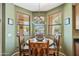 The dining area features a bay window with pool views and custom woodworking at 7342 E Norwood St, Mesa, AZ 85207
