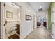 Hallway view to the bathroom and bedroom with tile floor and neutral wall paint at 7342 E Norwood St, Mesa, AZ 85207