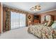 Spacious main bedroom features a ceiling fan, a TV, and a sliding glass door to the balcony at 7342 E Norwood St, Mesa, AZ 85207