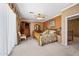 Comfortable carpeted main bedroom with ceiling fan, TV, and attached bathroom at 7342 E Norwood St, Mesa, AZ 85207