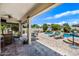 Beautiful covered patio transitions to a backyard featuring a sparkling pool, spa and outdoor seating at 7342 E Norwood St, Mesa, AZ 85207