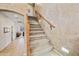 Staircase with textured wall finish, carpeted steps, and wood railing at 7342 E Norwood St, Mesa, AZ 85207